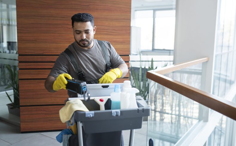 medium-shot-man-walking-with-cleaning-cart